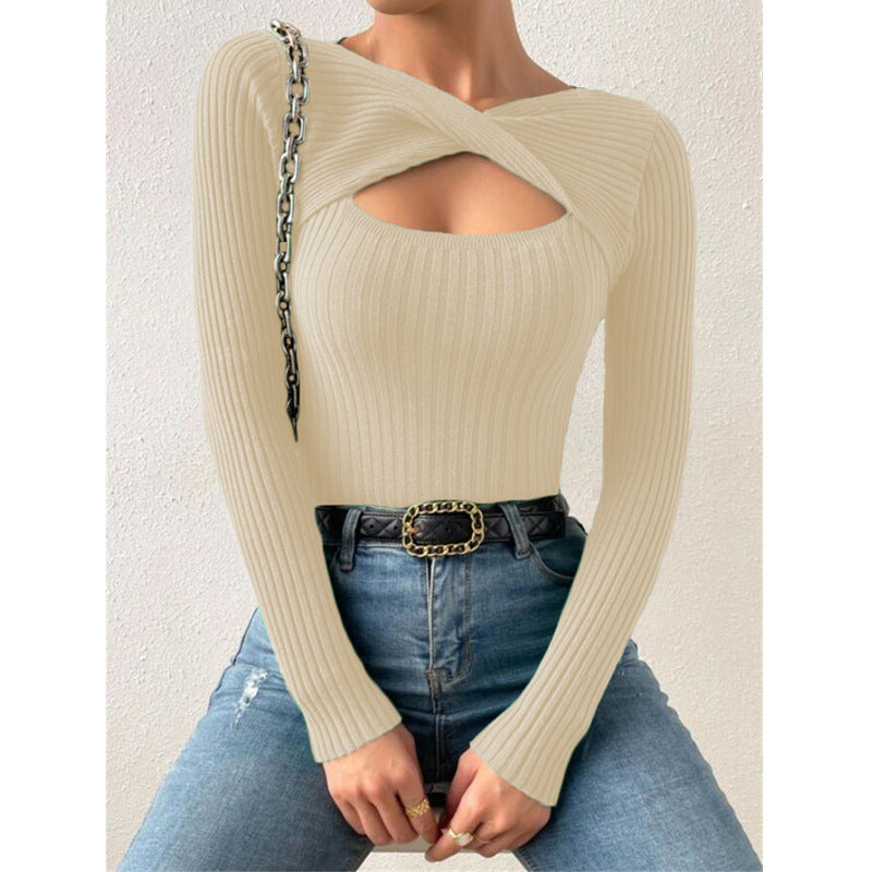 Person wearing a beige ribbed sweater and blue jeans with a white background diamond sadaf